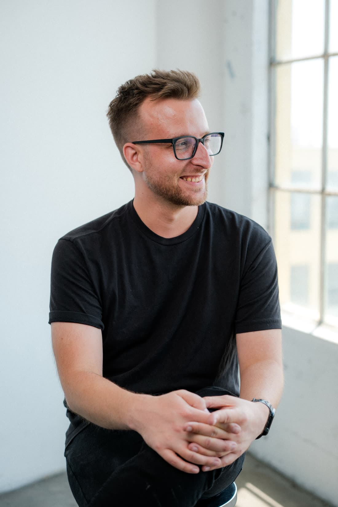 David Ryan Olson, mix engineer, seated by a window